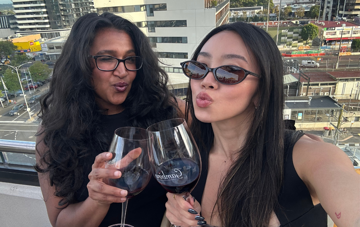 Two young women drinking wine